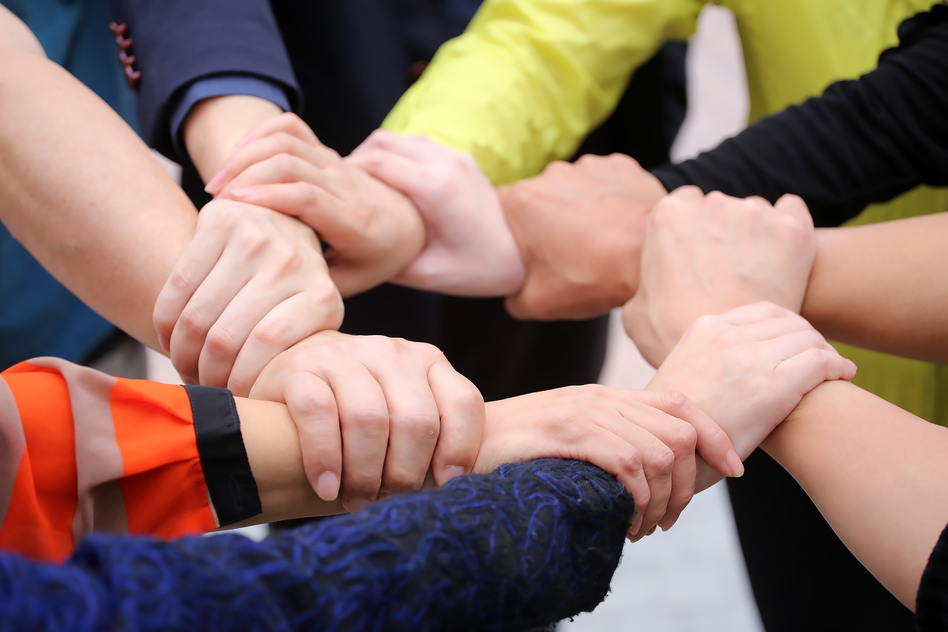 Group of hands holding on to each other to show unity